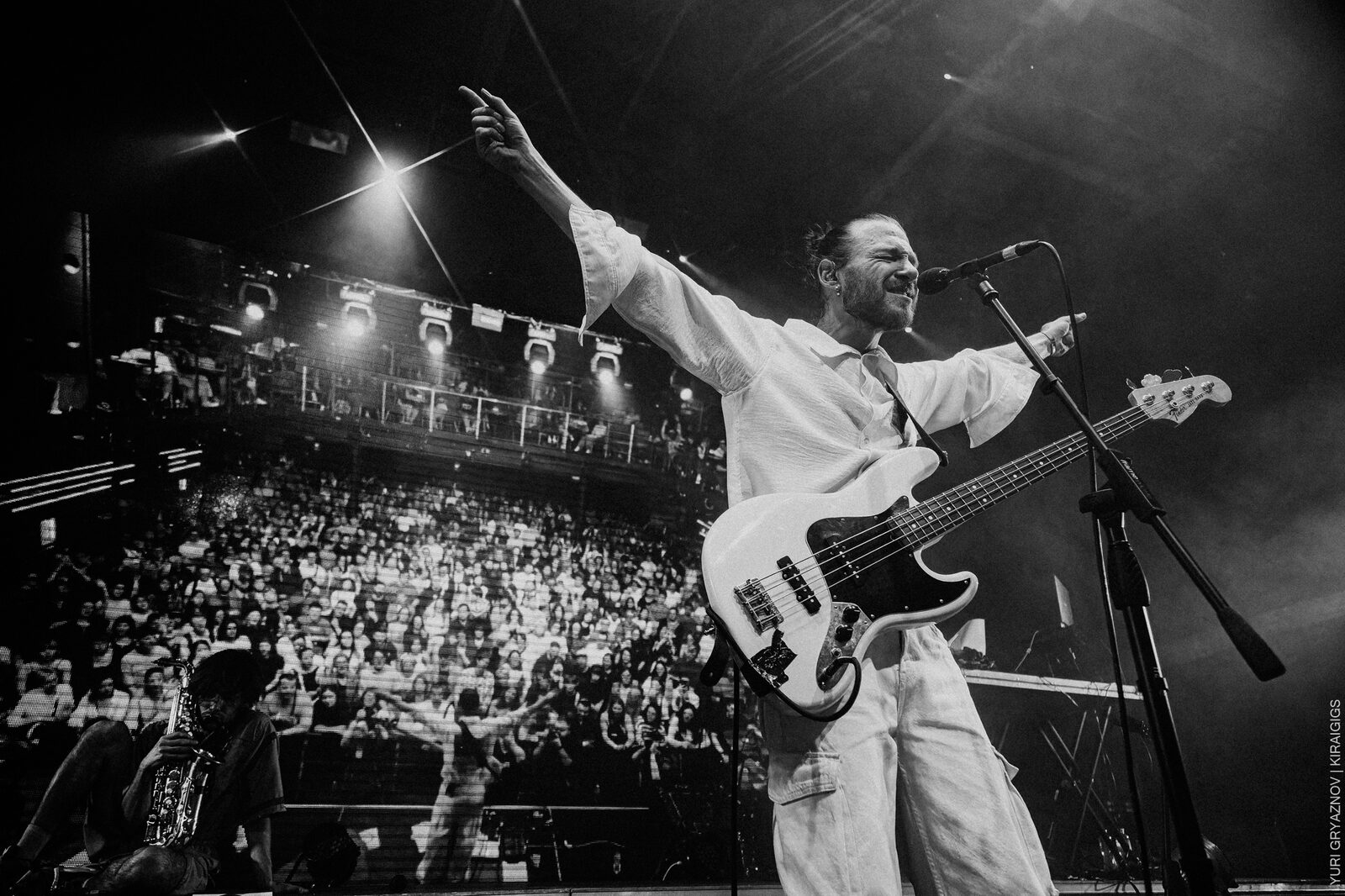 Stas Koroliov live — black-and-white, singing with arm raised