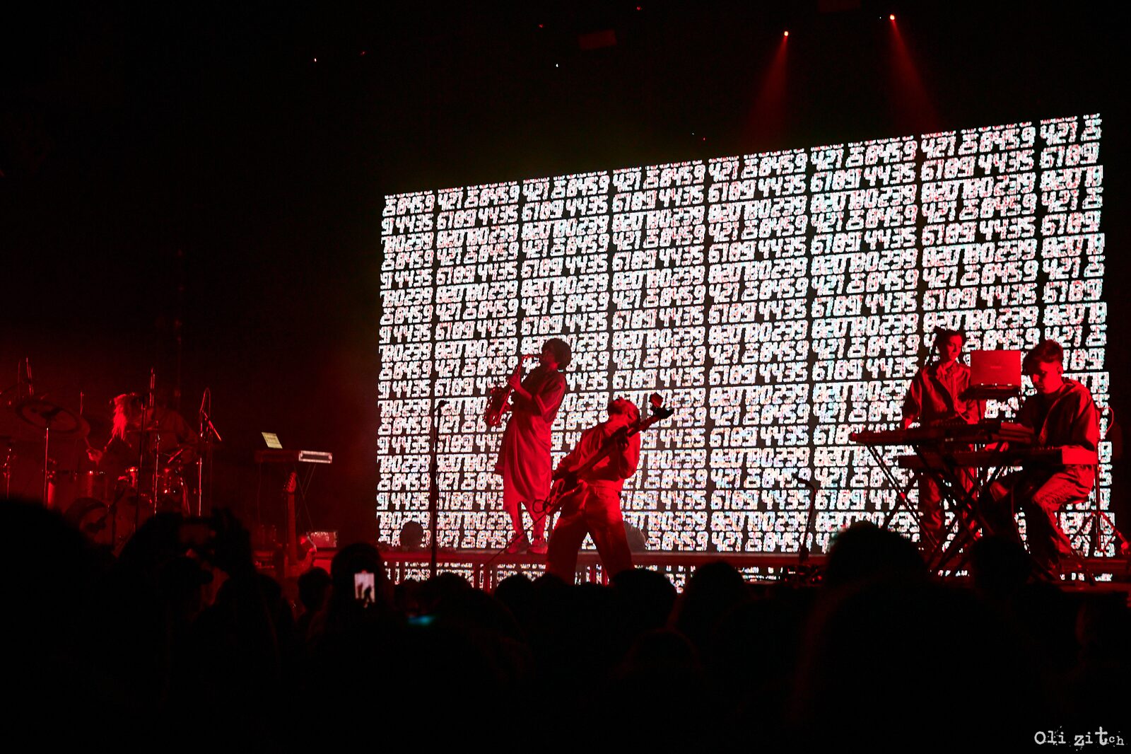 Stage screen with red visuals during the solo show